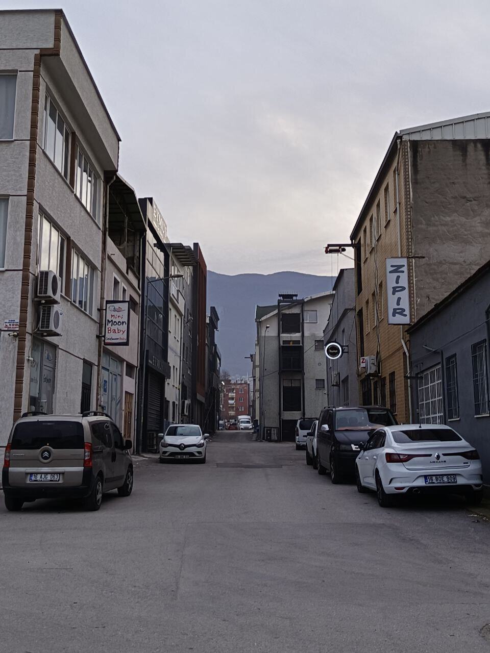 Photo of a city street in Turkey with mountains in the background.