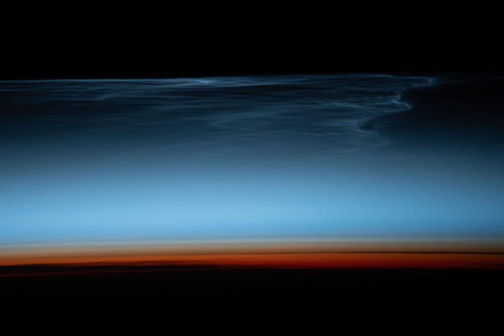 NASA Photo: Noctilucent clouds above the south Pacific Ocean