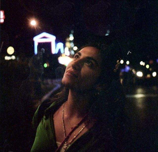 Sarah Younan at night in a city looking up.